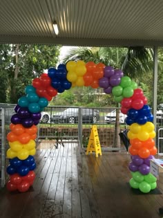 an arch made out of balloons on a deck