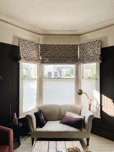 a living room filled with furniture and windows