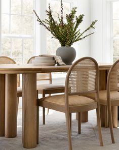 a table with chairs and a vase on it