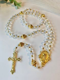 This rosary is delicately handmade with glass crystal beads, gold brass beads and braided waxed cord secured with melted barrel knots that make the rosary strong and durable.  P.S. As I make each rosary by hand I pray for the salvation of the souls of whoever prays with this rosary 🙏🏻 Brass Rosary Parts, Gold Hand-strung Spiritual Rosary, Rosary Design, Body Jewelry Diy, Crystal Rosary, Colorful Bead Bracelets, Rosary Jewelry, Custom Rosary, Clay Crafts For Kids