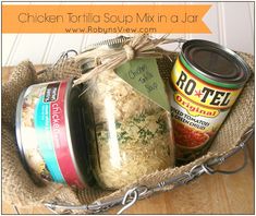 a basket filled with lots of food on top of a wooden table next to a jar