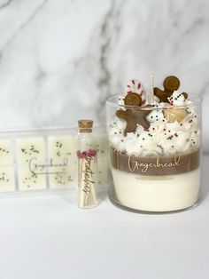 a cup filled with whipped cream and cookies on top of a counter next to other items