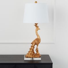 a lamp that is sitting on top of a night stand next to a black dresser