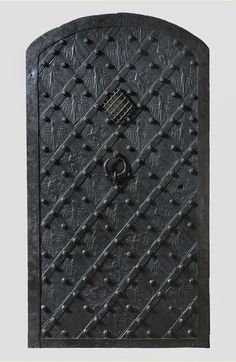 an iron door with intricate designs and knobs on the front, is shown in black