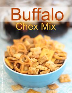 a blue bowl filled with chex mix on top of a table