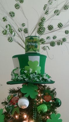 a st patrick's day tree is decorated with shamrocks and hats for the holiday