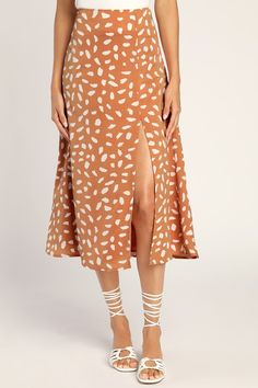 You'll be the height of style when you've got the Lulus Getting Glam Peach Print Slit Midi Skirt! Lightweight woven fabric features an abstract white print as it shapes this chic skirt that has a high, fitted waist, falling to a midi hem with a flirty side slit. Hidden zipper/clasp at side. Fit: This garment fits true to size. Length: Mid-calf length. Size medium measures 32.5" from waist to hem. Waist: Fitted - very fitted at natural waist. Hip: Loosely Fitted. Fabric: Fabric has no stretch. Li Orange Midi Skirt, Peach Print, Chic Skirt, Midi Skirt Outfit, Get Glam, Chic Skirts, Orange Print, Dot Skirt, Dot Print