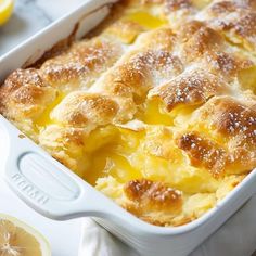 a casserole dish with lemons and powdered sugar on the top is ready to be eaten