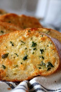 two slices of bread sitting on top of a towel next to each other with cheese and spinach sprinkled on them