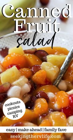 a bowl full of fruit salad with a spoon in it and the words, canned fruit salad