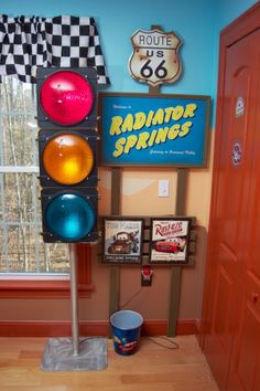 a traffic light sitting in front of a window next to a sign and a bucket