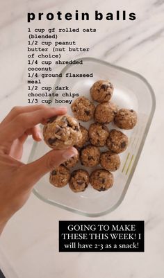 a hand holding a cookie doughnut in front of a plate with chocolate chip cookies on it