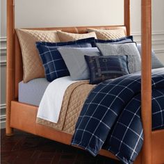 a bed with blue and tan comforters in a bedroom