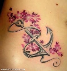 a woman's stomach with flowers on it and the letter e in the middle