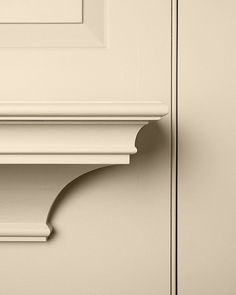 a close up of a white door with a clock on it's side panel