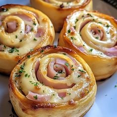 some ham and cheese rolls on a plate