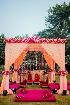 an outdoor wedding set up with pink and white decor