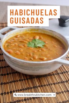 a white bowl filled with beans and garnished with cilantro