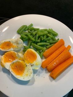 eggs, green beans and carrots on a white plate