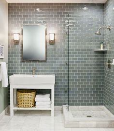 a white sink sitting under a bathroom mirror next to a walk in bathtub and shower