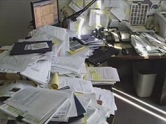 an office desk full of papers and paperwork