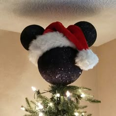 a mickey mouse hat on top of a christmas tree