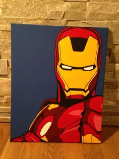 a painting of iron man sitting on top of a wooden floor next to a brick wall