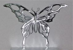 a metal butterfly sculpture sitting on top of a table