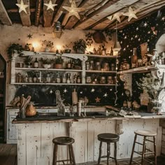 an old fashioned kitchen with wooden floors and stars on the wall above the bar area