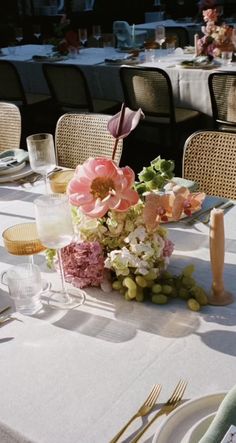 the table is set with flowers and wine glasses