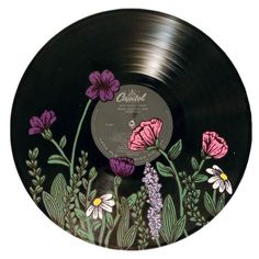 an old record with flowers painted on it