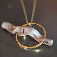 a necklace with an animal's head in a circle on a black table top