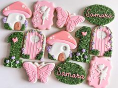 decorated cookies are arranged in the shape of houses and trees, with words on them