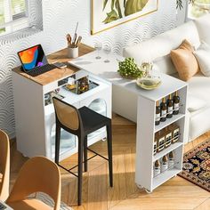 a living room filled with furniture and a laptop computer sitting on top of a table