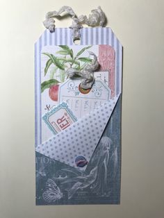 an envelope with a plant on it is attached to a wall or door hanger