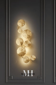 an illuminated wall light with shells on it