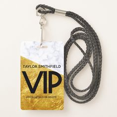 a black and white lanyard with a gold foil tag on the end that says taylor smithfield