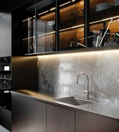 a modern kitchen with stainless steel sink and cabinets