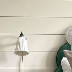 a bedroom with white walls and green headboard