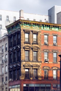 an old brick building in the city with lots of windows on it's side