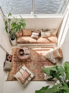 a living room filled with lots of furniture next to a large window overlooking the water