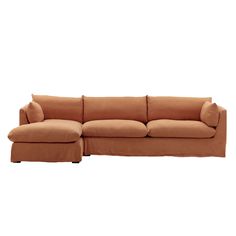 a brown couch with pillows on it and a footstool in front of the couch