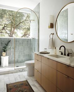 a bathroom with two sinks, a toilet and a shower