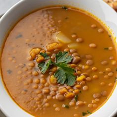 a white bowl filled with soup and garnished with cilantro