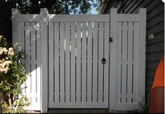 a man standing in front of a white gate