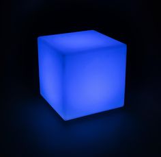 an illuminated cube in the dark on a black background