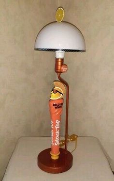 a lamp that is sitting on top of a table with a light in the shape of an ice cream cone