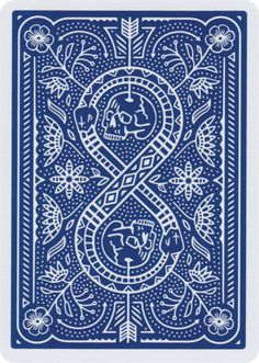 a blue and white playing card with an intricate design on the front, featuring a skull