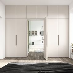 a bedroom with white cabinets and black rug