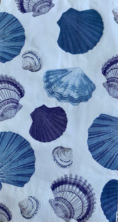 blue and white seashells are on the table cloth